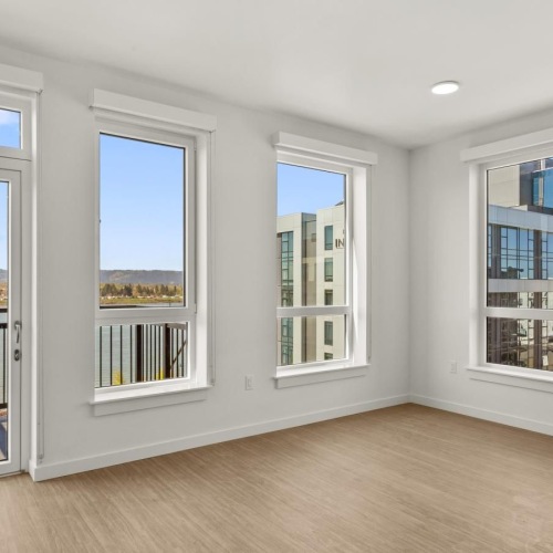 a room with windows and a wood floor