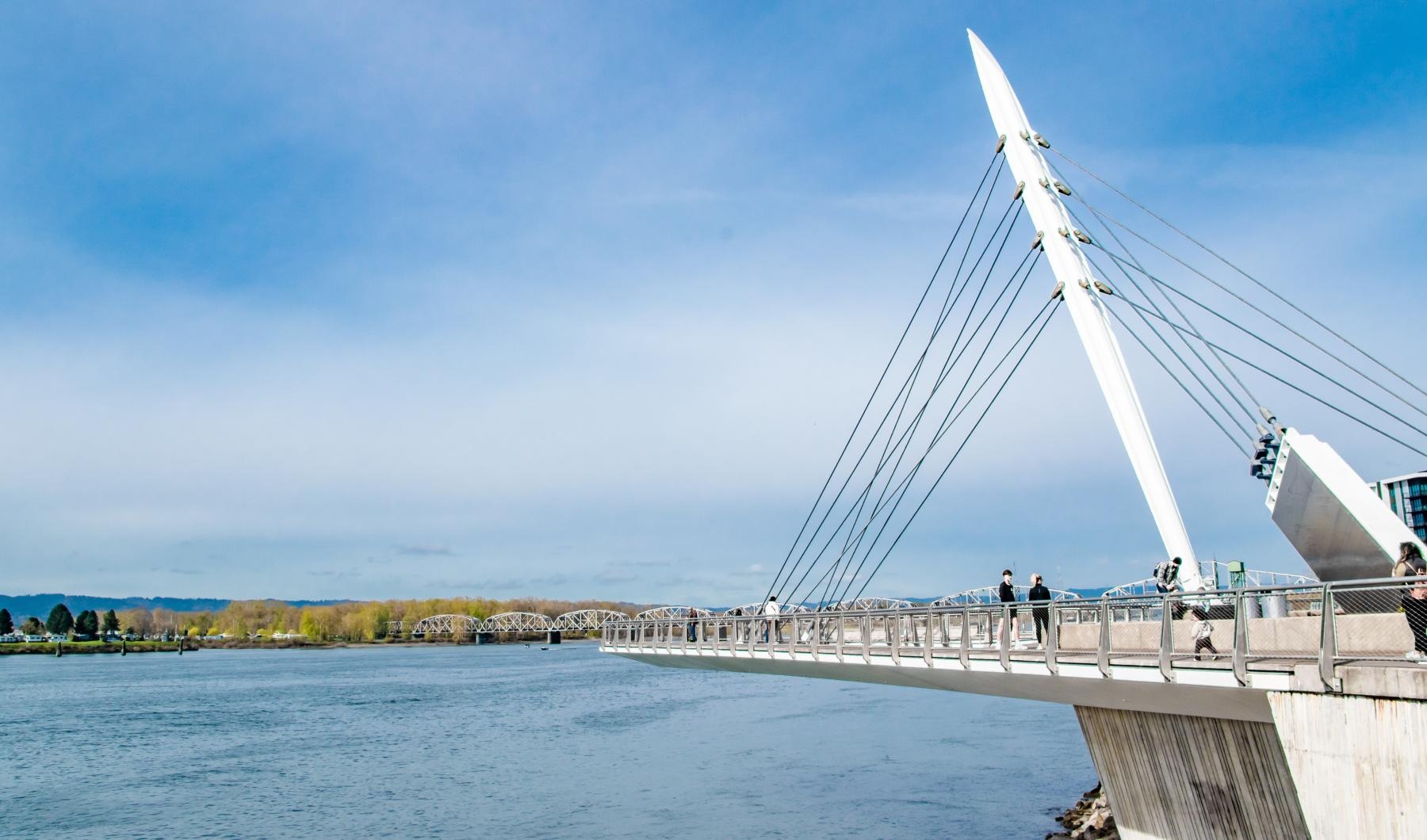 a pier with people overlooking a body of water